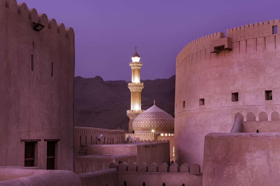 From Muscat: Nizwa Guided Tour with Optional Overnight Stay - Nizwa Fort after sunset: outer grounds, views, and the fee reminder