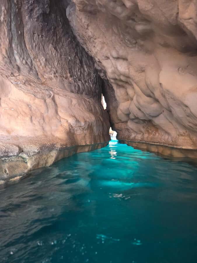 From Muscat: Wadi Shab Expedition - Hidden Cave: the swim-through moment and the waterfall pool