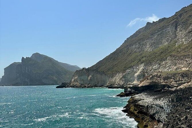 Full Day Guided Salalah a Combination of East and West tour - Taqah Street, plateau photos, and a beach with fishermen and birds